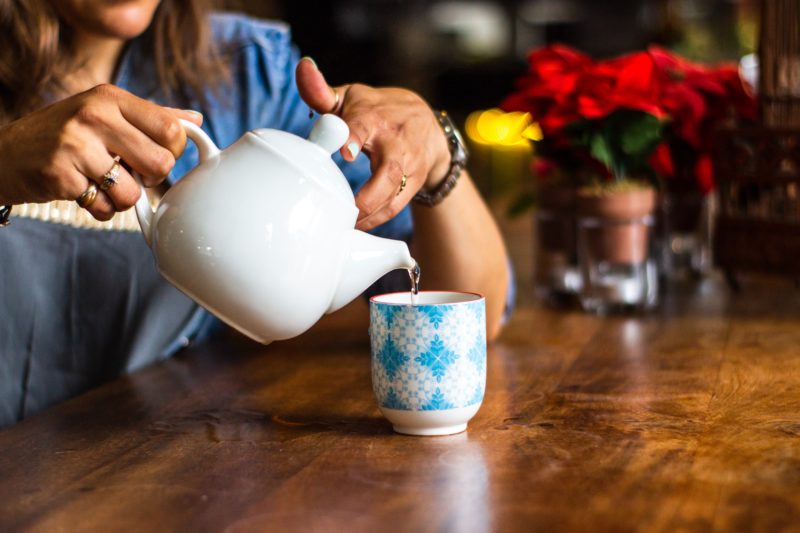 A catch up coffee, woman pouring tea in kitchen, ramsgate rooms